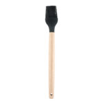 Black silicone basting brush with wooden handle for applying sauces, butter and marinades.