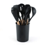 Le Regalo black silicone cooking utensils with wooden handles arranged inside a matching storage holder.